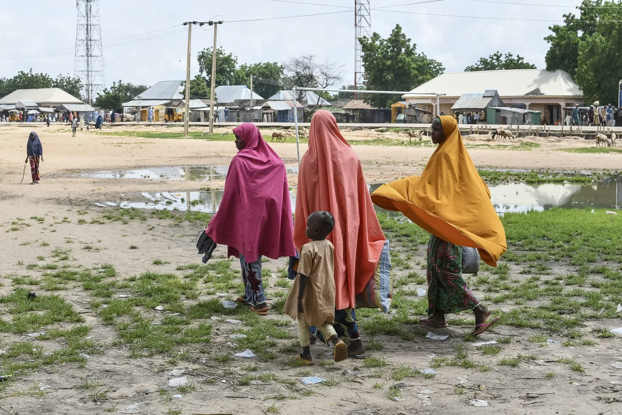 Survivors and relatives of victims of a suspected Boko Haram attack walk in Babban Gide on September 4, 2024. At least 81 people died and several remain missing after an attack by presumed Boko Haram jihadists in Yobe State, northeastern Nigeria, local officials confirmed.