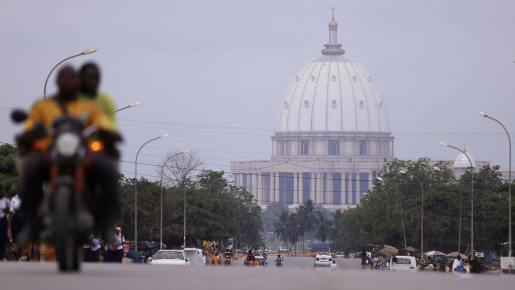 Aerial view of Yamoussoukro's iconic Notre Dame de la Paix Basilica, symbolizing the city's rapid urban transformation.