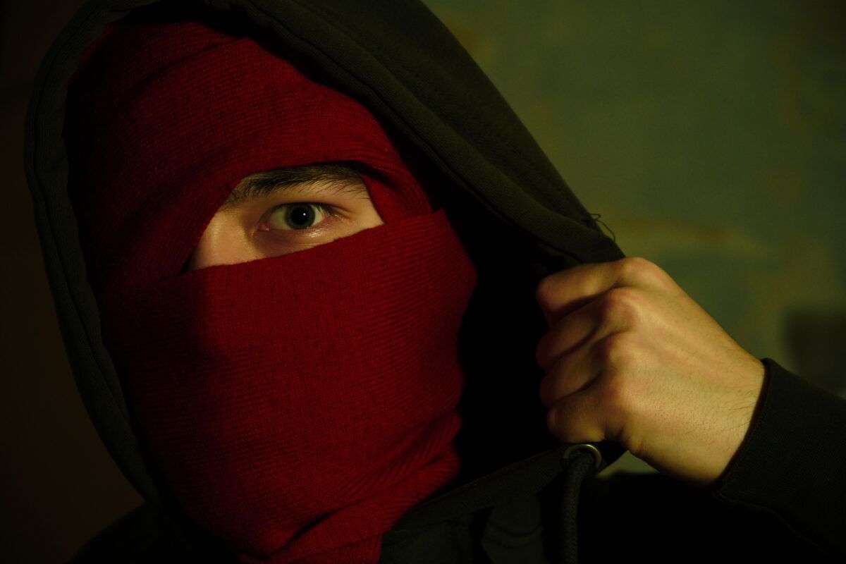 Militant using smartphone in dimly lit room