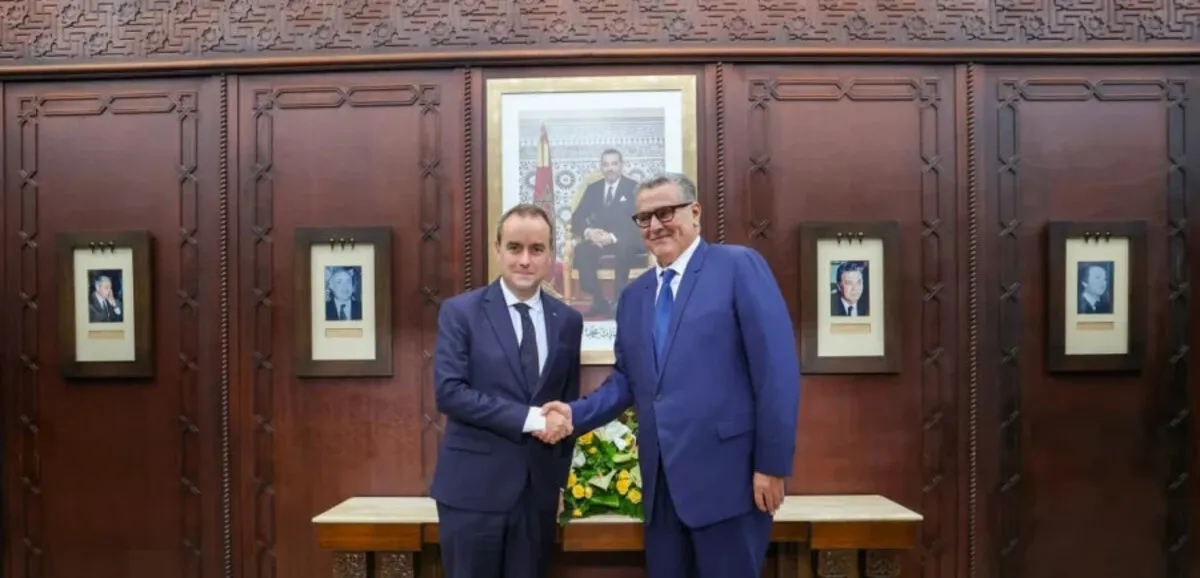 French and Moroccan leaders shake hands during a strategic partnership signing ceremony
