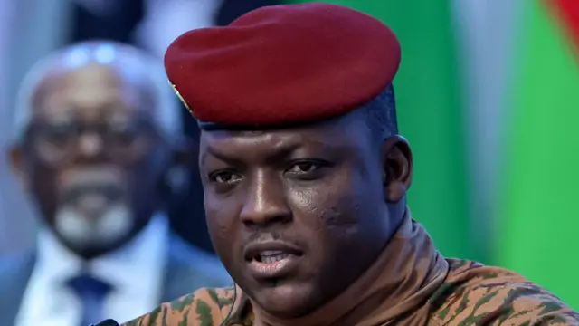 Ibrahim Traoré wearing a beige military uniform and red beret