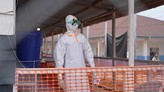 Health workers in protective gear at an Ebola treatment center