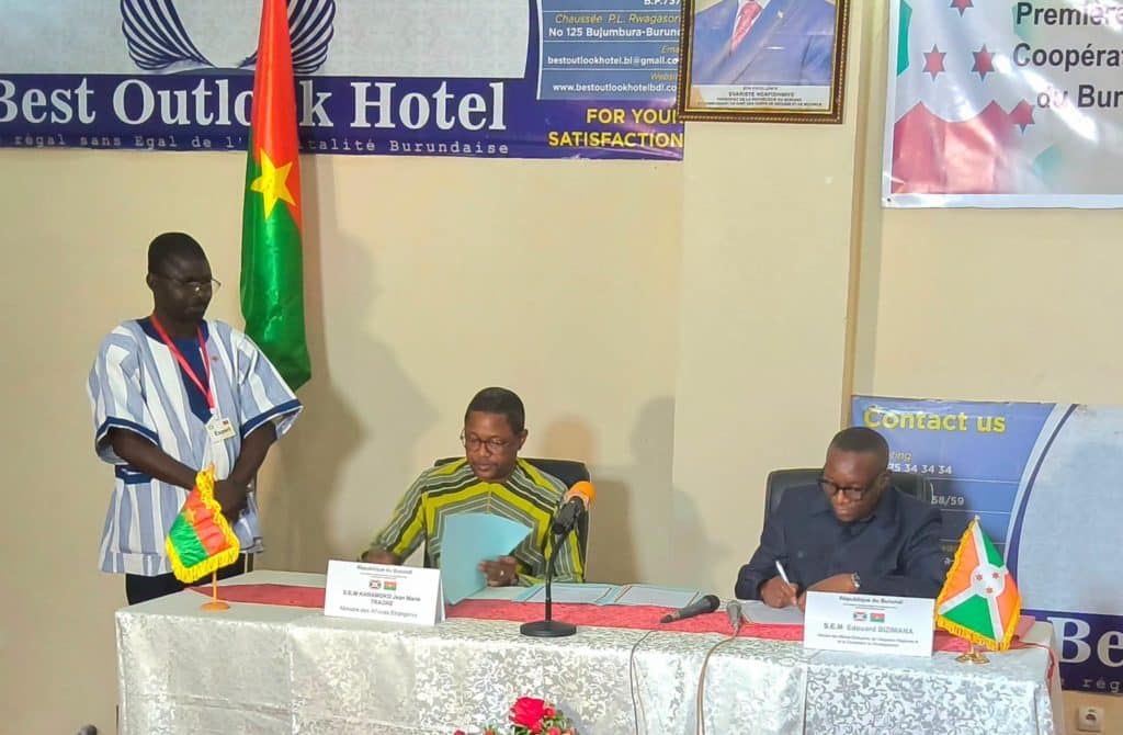 Officials from Burkina Faso and Burundi shake hands after signing cooperation agreements